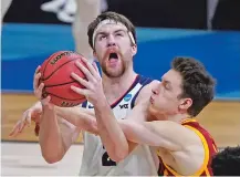  ?? DARRON CUMMINGS/ASSOCIATED PRESS ?? Gonzaga forward Drew Timme, left, is fouled by Southern California guard Drew Peterson on Tuesday in the NCAA Tournament in Indianapol­is. Timme scored 23 in the win.