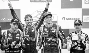  ??  ?? Belgium Thierry Neuville (2ndR) from Belgium and his co-driver Nicolas Gilsoul (2nd L) celebrate first place as New Zelands Hayden Paddon (L) and French Sebastien Ogier (R) applaud them after last superpower stage of the Orlen Rally Poland in Paprotki,...