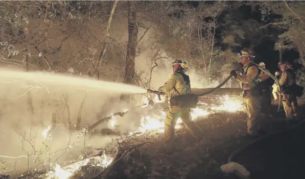  ?? PICTURE: MARCIO JOSE SANCHEZ ?? 0 Fire crews battling a wildfire at the weekend in Santa Rosa, California. Fires have killed at least 40 people and destroyed at least 5,700 homes