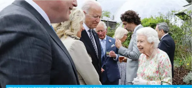  ?? —AFP ?? CARBIS BAY, UK: Britain’s Queen Elizabeth II (right) speaks with US President Joe Biden and US First Lady Jill Biden and leaders of the G7 during a reception at The Eden Project in south west England Friday.