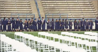  ?? Don Campbell / Associated Press ?? Graduates wait for the start of the St. Joseph High School commenceme­nt ceremony on June 6, 2021, in St. Joseph, Mich. High school graduation rates dipped in at least 20 states after the first full school year disrupted by the pandemic, according to a new analysis by Chalkbeat.