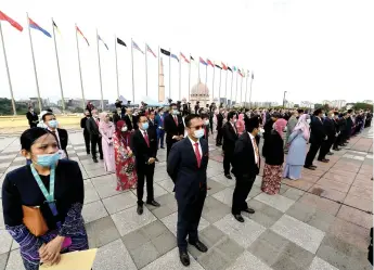  ?? — Bernama photo ?? Mask-wearing staff members of the Prime Minister’s Department gather for the assembly on Dataran Perdana at Perdana Putra.