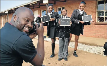  ?? Picture: EUGENE COETZEE ?? ON RECORD: Keep A Dream Alive founder Loyiso Mali helps W B Tshume Primary School pupils, from left, Nalo Pela, 12, Anele Desi, 11, and Nelisiwe Sompa, 14, capture their hopes for the future