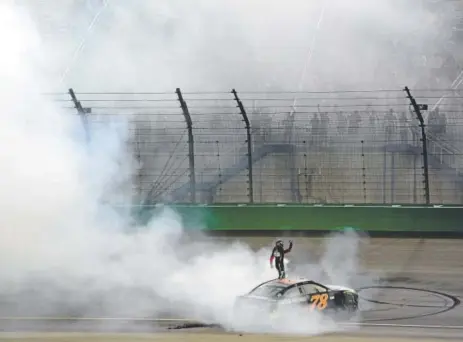  ?? Robert Laberge, Getty Images ?? Martin Truex Jr. of Denver-based Furniture Row Racing celebrates with a burnout Saturday night after winning the 400-mile NASCAR Cup race at Kentucky Speedway in Sparta. Truex has three victories this year and 10 in his career.