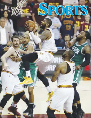  ?? AP ?? Cleveland Cavaliers star Kyrie Irving (center) rams straight to the basket against the Boston Celtics in Game 4 of the Eastern Conference finals on Tuesday.