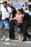  ?? MARY ALTAFFER - THE ASSOCIATED PRESS ?? Police help people cross the street outside the Bronx Lebanon Hospital in New York after a gunman opened fire there on Friday.