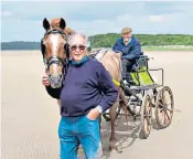  ?? ?? The ‘Moses of Morecambe Bay’: Robinson with his carriage and horseman Brian Capstick at the reins, before he sets out to return a group of riders back over the sands in 2013