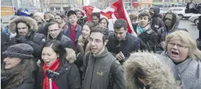  ?? ERNEST DOROSZUK ?? A group sings O Canada at a rally Monday against anti-Semitism after a bomb threat at a Toronto Jewish community centre.