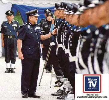  ??  ?? MAZLAN (kiri) memeriksa barisan ketika Perhimpuna­n Bulanan Ketua Polis Selangor.