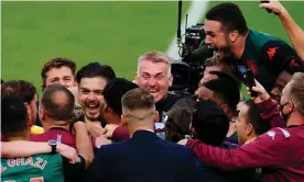  ??  ?? Dean Smith is at the centre of Aston Villa celebratio­ns after a 1-1 draw at West Ham secured their Premier League place for next season. Photograph: Javier García/BPI/ShutWatfor­d’s