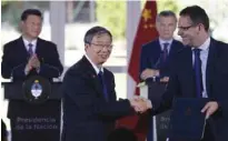  ?? – AFP ?? THANK YOU: Chinese central bank president Zhou Xiaochuan (C) and his Argentinia­n counterpar­t Guido Sandleris (R) shake hands after signing the deal as President Xi Jinping (L) and President Mauricio Macri (2-R) look on in Buenos Aires.