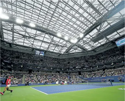  ?? MIKE STOBE/GETTY IMAGES FOR USTA ?? Rafael Nadal plays against Dusan Lajovic under the roof at the U.S. Open on Tuesday in New York City. After the match, Nadal complained about the noise level on the court when the roof is closed.