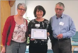  ??  ?? Pamela Hamilton and Sharyn Morgan receive the award from Dr David Alston, chairman of NHS Highland.