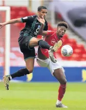  ??  ?? Swansea’s Yan Dhanda challenges Forest’s Nuno de Costs during Wednesday’s 2-2 draw