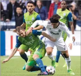  ?? The Canadian Press ?? Vancouver Whitecap Christian Bolanos, right, fights for control of the ball with Seattle Sounder Harry Shipp during an MLS soccer game Friday in Vancouver.