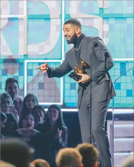  ?? Photograph­s by Robert Gauthier Los Angeles Times ?? DRAKE makes a surprise visit to the Grammys stage Sunday at Staples Center to receive his award for rap song for “God’s Plan.”