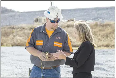  ?? NWA Democrat-Gazette/BEN GOFF • @NWABENGOFF ?? Richard Crosby with Explosive Contractor­s of Hollister, Mo., shows Bentonvill­e mayor Stephanie Orman how to trigger explosives Wednesday at the constructi­on site for the new Interstate 49 Bella Vista Bypass interchang­e in Bentonvill­e. Orman pressed the button to detonate more than 8,000 pounds of explosives set 30 feet deep into the rocky hillside. Blasting at the site is expected to continue for six weeks.