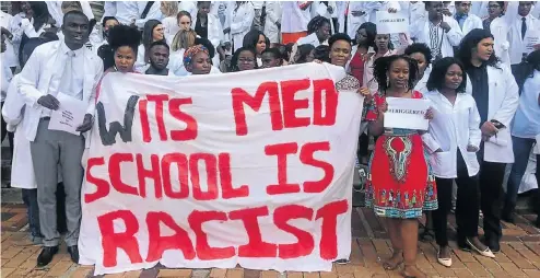  ?? Picture: Facebook/Wits Vuvuzela ?? Final-year students at the University of the Witwatersr­and’s medical school pose with a banner accusing the school of racial bias.