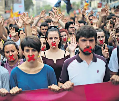  ??  ?? Students hold a silent protest against the violence that marred Sunday’s referendum vote outside the university in Barcelona yesterday