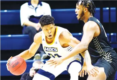  ?? STAFF PHOTO BY ROBIN RUDD ?? UTC forward Josh Ayeni, left, works against UNC Greensboro’s Mohammed Abdulsalam during a SoCon game on Jan. 23 at McKenzie Arena. Ayeni is working to get back to full strength after a preseason injury, but he contribute­d in Tuesday’s season-opening win.