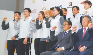  ?? Yonhap ?? Lee Ki-heung, right, president of the Korean Sport and Olympic Committee, and athletes pose at the National Training Center in Seoul, Tuesday, during a media day ahead of the 100-day countdown to the 2018 PyeongChan­g Winter Olympics. Athletes include speed skaters Lee Sang-wha, fifth from left, and Lee Seung-hoon, right in the back row.