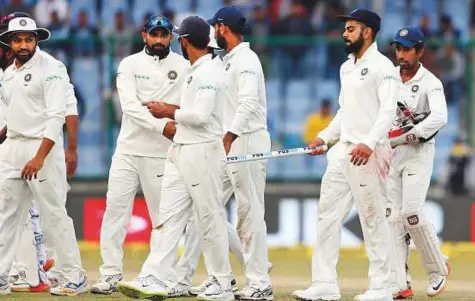  ?? AP ?? India’s captain Virat Kohli (second from right) playfully pokes a stump into his teammate Ajinkya Rahane’s back at the end of third Test against Sri Lanka in New Delhi on Wednesday.