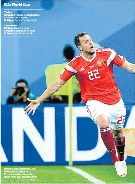  ?? Photo / AP ?? Russia’s Artyom Dzyuba, left, celebrates with Mario Fernandes after scoring his side’s third goal against Egypt.