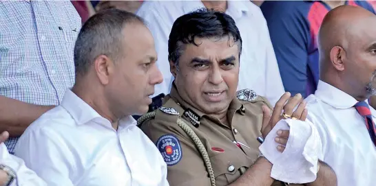  ??  ?? Police Chief Pujith Jayasunder­a, much in the news these days, seen with Public Safety, Law and Order Minister Sagala Ratnayake yesterday at the CR&amp;FC grounds where they watched the rugger match between Police and CR&amp;FC. Pic by Amila Gamage