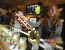  ?? DAVID ZALUBOWSKI/THE ASSOCIATED PRESS FILE PHOTO ?? Queen’s Park could mandate that the LCBO control the distributi­on of marijuana, which could be sold through pharmacies such as Rexall.