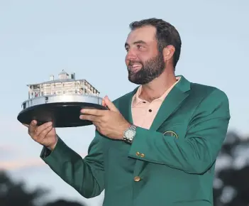  ?? GETTY IMAGES ?? Scottie Scheffler of the United States poses with the Masters trophy after winning the 2024 tournament at Augusta.