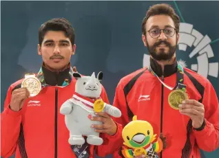  ?? PTI ?? Gold medal winner Saurav Chaudhary ( left) and bronze medallist Abhishek Verma pose with their medals from the men’s 10m air pistol event at Palembang on Tuesday.