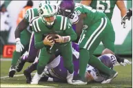  ?? Al Bello / Getty Images ?? Jets quarterbac­k Sam Darnold is sacked against the Vikings during Sunday’s game in East Rutherford, N.J.