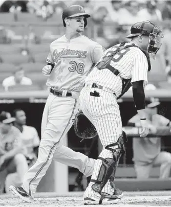  ?? ELSA/GETTY IMAGES ?? Veteran catcher Caleb Joseph scores a run against the Yankees on Wednesday. “It’s odd, for a team that won [96] games just four years ago, for 22 of the 25 guys from that team to be gone is odd to me,” he said.