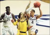  ?? David Butler II / USA Today ?? UConn guard Tyrese Martin, right, drives the ball against Marquette forward Theo John during a game in February.