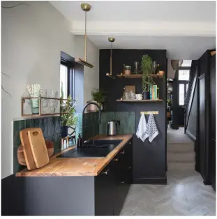  ??  ?? Taking on a whole-house renovation meant Stephanie had to be smart with the budget: ‘We chose IKEA’s Kungsbacka kitchen and added brass handles to tie in with the industrial-style shelving and to lift the black cabinetry’