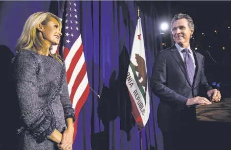  ?? Jay L. Clendenin / TNS ?? Gov.-elect Gavin Newsom spotlights his wife, Jennifer Siebel Newsom, during his victory speech at a party in S.F. on June 5.