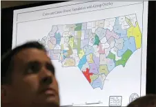  ?? GERRY BROOME — THE ASSOCIATED PRESS ?? A state district map is in the background as a three-judge panel of the Wake County Superior Court presides over a trial in Raleigh, N.C., in 2019.