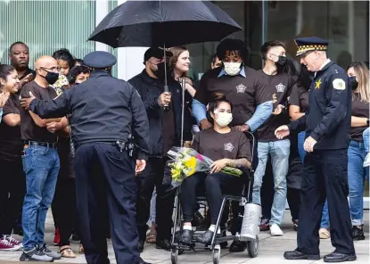  ?? ANTHONY VAZQUEZ/SUN-TIMES ?? Officer Fernanda Ballestero­s, who was shot last week on the South Side, is greeted by fellow officers outside the University of Chicago Medical Center on June 6.