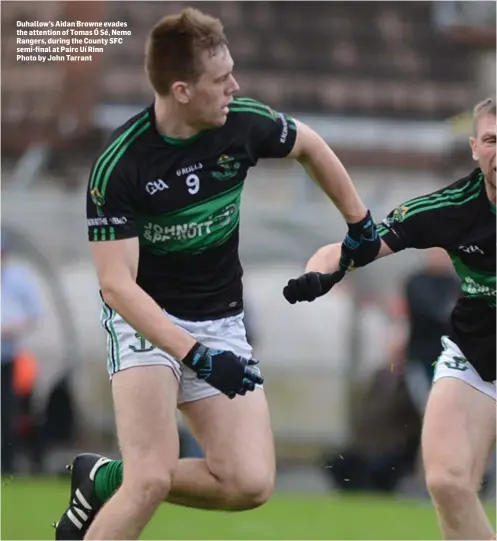  ?? Photo by John Tarrant ?? Duhallow’s Aidan Browne evades the attention of Tomas Ó Sé, Nemo Rangers, during the County SFC semi-final at Pairc Uí Rinn