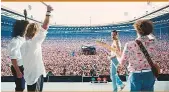  ?? Photos by New York Times, Rex Features and supplied The band’s iconic Live Aid set in 1985 has been recreated in the film. ??