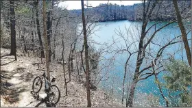  ??  ?? Sections of the Karst Loop of the Monument Trails visit the Van Winkle Hollow arm of Beaver Lake. The loop offers a 7.8-mile hike or mountain bike ride at Hobbs State Park-Conservati­on Area. (NWA Democrat-Gazette/Flip Putthoff)