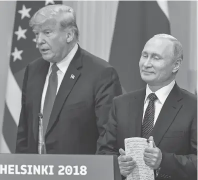  ?? YURI KADOBNOV / AFP / GETTY IMAGES ?? U.S. President Donald Trump and Russia President Vladimir Putin arrive for a press conference Monday in Helsinki.