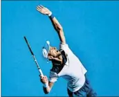  ?? SAEED KHAN/GETTY-AFP ?? Novak Djokovic serves in his four-set win over Gael Monfils on an oppressive­ly hot Thursday at the Australian Open.