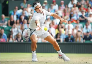  ?? ANDREW COULDRIDGE / REUTERS ?? Switzerlan­d’s Roger Federer reaches for a forehand during his third-round victory over Germany’s Mischa Zverev at Wimbledon on Saturday. Seven-time champion Federer made the fourth round for the 15th time with a 7-6 (3), 6-4, 6-4 win.