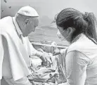  ?? VATICAN MEDIA/AP ?? Pope Francis baptizes an infant named Miguel Angel on Friday at the hospital where he is being treated for bronchitis. Francis is expected to be discharged on Saturday.