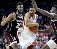  ?? NWA Democrat-Gazette/BEN GOFF ?? Arkansas guard Jalen Harris splits the defense of Texas A&M forwards Josh Nebo (left) and Emanuel Miller in the second half Saturday at Walton Arena in Fayettevil­le. Harris had 6 points, 5 assists and 4 rebounds as he came off the bench in place of Adrio Bailey, who fouled out at the 12:12 mark.