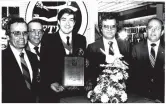  ??  ?? Ian Henry (father), Florist Transworld Delivery (FTD) representa­tive, Keith and Rick Evans. The Evans family received an award from FTD in 1984, as well as many others over the years.