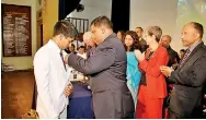  ??  ?? Baghya Ranasinghe receiving the Ryde Gold Medal for Most Outstandin­g Student, from Governor Gunaratne