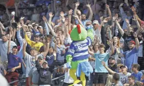  ?? ADAM CAIRNS/COLUMBUS DISPATCH ?? Columbus Clippers mascot Krash fires up the capacity crowd during a game against the Toledo Mud Hens in June. Health experts say people need to determine the risk they’re comfortabl­e with when attending events such as a baseball game. Outdoor events where people are socially distanced are safer, they say.