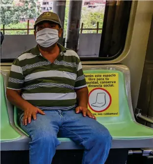  ??  ?? SIGNS OF THE TIMES (above): Masked and in designated seats, metro car passengers in Medellin, Colombia, await departure in early May. The COVID-19 “virus vernacular” has been growing since January, and the medical meaning of “face mask” has clearly overtaken its use as a scuba essential or beauty treatment. Lexicograp­hers have noted that the words in constructi­ons such as “social distancing” and “selfisolat­ion” aren’t new: they’re just being used in new ways.